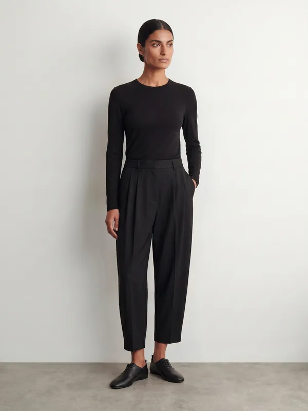 Editorial, black knit top, tapered trousers